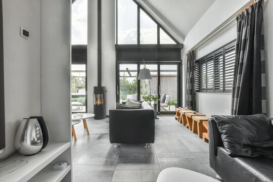 Leathers couches placed near firebox in modern house