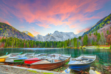 Breathtaking view of sunset over Fusine lake with Mangart peak on background.