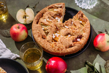Apple pie. Sponge cake with apples on a green background