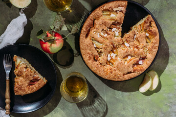 Apple pie. Sponge cake with apples on a green background