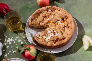 Apple pie. Sponge cake with apples on a green background
