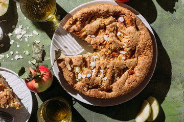 Apple pie. Sponge cake with apples on a green background