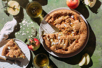 Apple pie. Sponge cake with apples on a green background