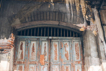 Old wooden door with traces of stains, original paint.