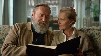 Old aged couple remembering happy moments with photo album. Senior people - Powered by Adobe