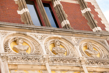 Facade of old building with carved busts