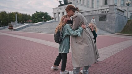 mom escorts her little daughters to school. happy family kid dream school concept. schoolgirl hurrying class for lesson to school. kid and mom lifestyle goodbye before school. High quality 4k footage