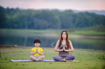 Fototapeta na wymiar Mother and child doing yoga exercises