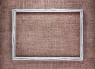 Wooden frame on brown burlap background with beautiful brown fabric canvas texture as vintage burlap background with burlap texture and beautiful burlap color