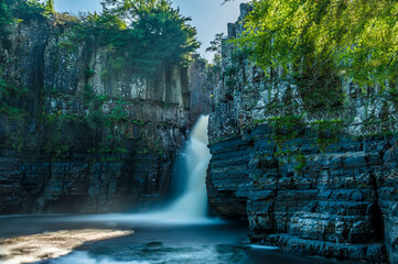 A long exposure view towards the High Force waterfall on the River Tees in summertime
