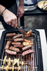 Preparing barbeque on a electrical modern grill outdoors.