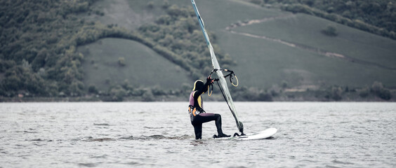 Windsurfer surfing on a windy day at the river.