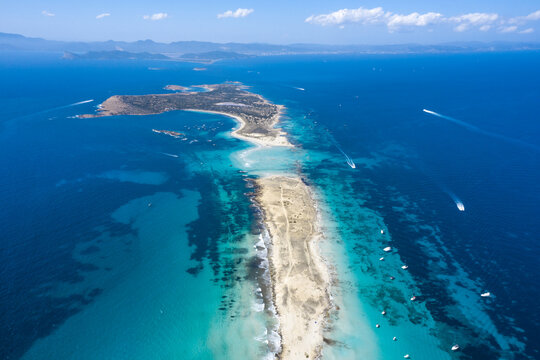 Island between sea with motorboats in summer