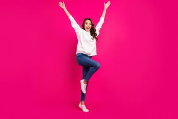 Photo of excited amazed crazy lady raise hands wear white hoodie jeans footwear isolated pink color background