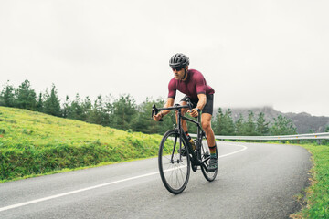 Bicyclist riding bike during training on countryside road