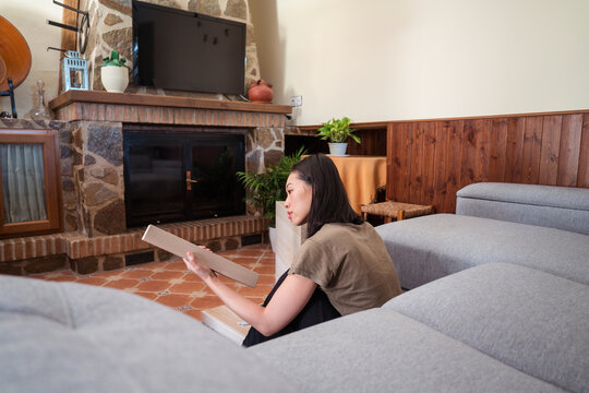 Asian woman assembling table in living room