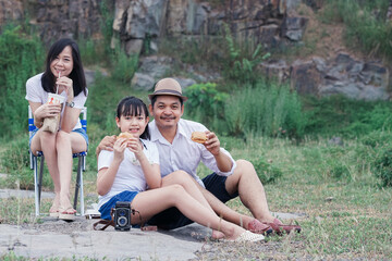 Family picnicking in the midst of nature with the cliff of background