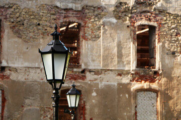 Fototapeta na wymiar Old lantern on the background of the ancient wall.