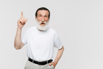 European senior man pointing finger upward and looking at camera