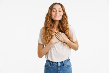 Obraz premium Young ginger woman smiling and holding hands on her chest