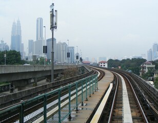 train track and transmission towerat malaysia background  petronas twin tower - obrazy, fototapety, plakaty