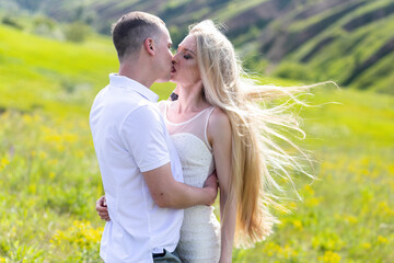 Smiling couple hugging in the park on a sunny day