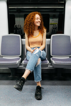 Cheerful passenger with crossed legs on train