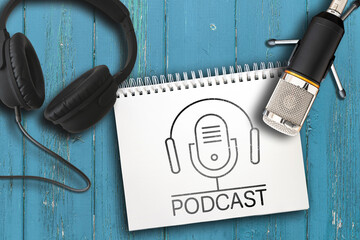 top view of headphones, microphone and note pad with PODCAST logo on rustic wooden table