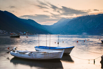 Fototapeta na wymiar Boats sitting at sunset on Kotor Bay at Perast,Montenegro in the late summer.