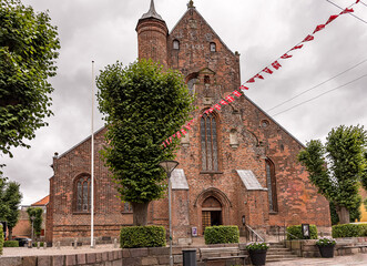 west facade and entry of Haderslev cathedral, decorated with danish flags