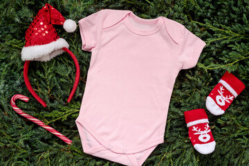 Close up pink blank template baby bodysuit with copyspace and Christmas Holiday concept. Top view...