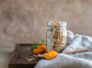 Homemade granola with pumpkin seeds in a glass jar. Dry breakfast cereals. Healthy eating, dieting...