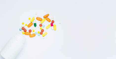pills and pill bottles on white background,Spilled Pill Bottle isolated.Top view, pharmacology concept. white pills