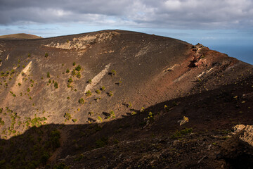 Mouth of some of the volcanoes, with ancient lava and pine trees before eruption in Cumbre Vieja Natural Park, Canary Islands, Spain