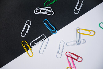 Top view of colorful paper clips on Black and white background