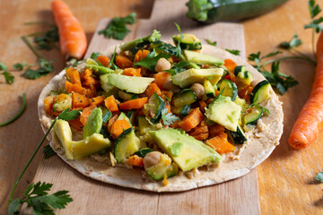 Vegan burrito with chickpeas, zucchini, carrots and avocado