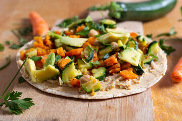 Vegan burrito with chickpeas, zucchini, carrots and avocado