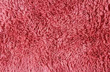 Background from pink fluffy fabric. Plush texture