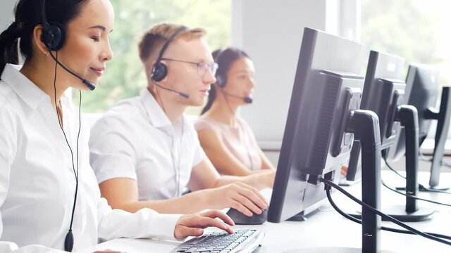 Diverse team of professionals is working in the phone support office. Working day of sales managers in the call center. Concept of business, telephone consulting and problem solving.