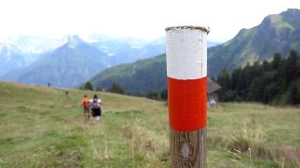 red and white signal to indicate the existence of a path marked out for tourists on a mountain...