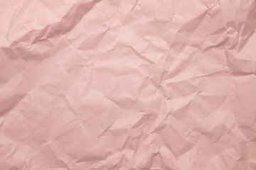 Pastel pink crumpled paper texture background with space paper for text. Abstract rose paper background.