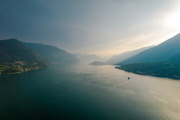 Photo of foggy mountains in Como lake in Lombardy, Italy. Sunset view over the mountain