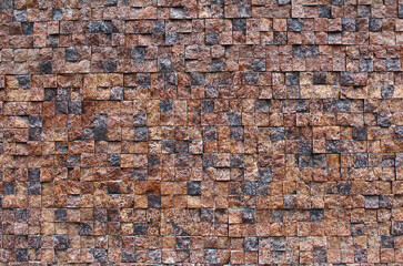 A wall of stone squares. Facade of stone square blocks