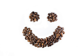 Smiley face made of coffee beans on white background