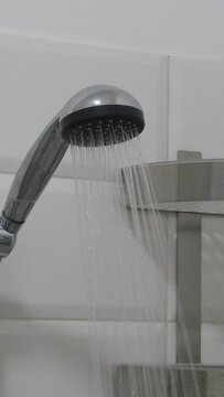 Bathroom interior. Shower head with water stream. Modern shower splashing water in the bathroom.