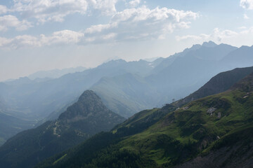 Panoramic view of silhouette mountain scenery with mountains in the background and meadow, grass on a nice, sunny day