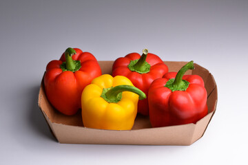 Colorful mix of peppers paprika capsicum in a n a paper container. Fresh colorful bell pepper box. Close up.