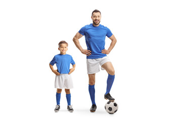 Young man and a boy with a soccer ball wearing blue sport jersey