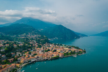 Fototapeta na wymiar Aerial view of Menaggio village on a cloudy day. Menaggio is a picturesque and traditional village, located on the western shore of Lake Como, Italy