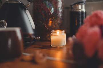 Cozy home lifestyle: a cup of tea with cookies on a wooden table top with beautiful carnation flowers